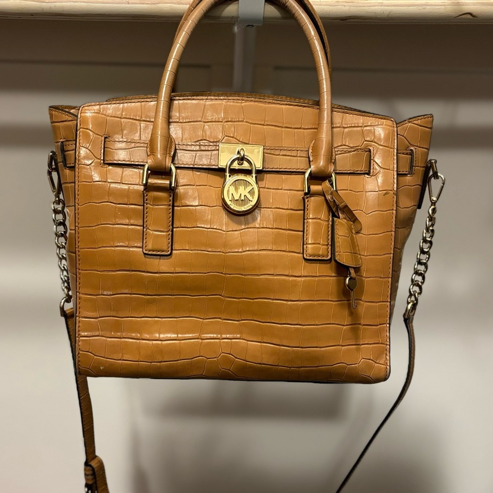 Authentic Michael Kors. A bit of wear on handle.